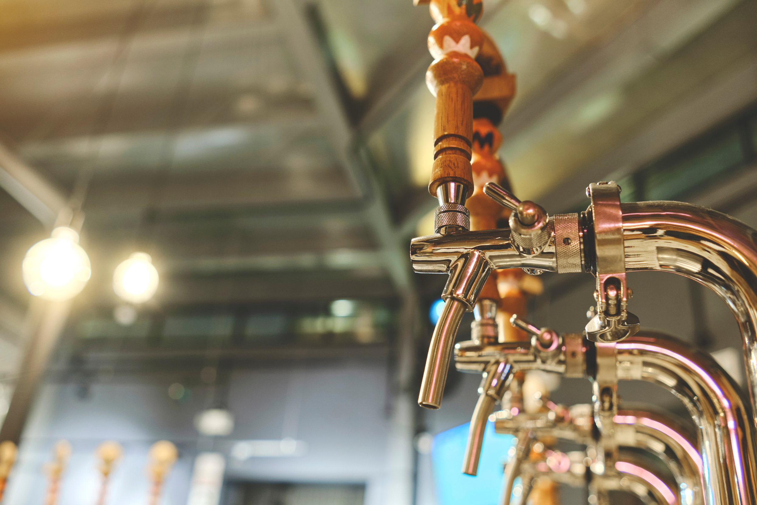 Row of draft beer taps at a bar. Beer taps in a row in perspective. Close up of beer Tap. Selective focus.